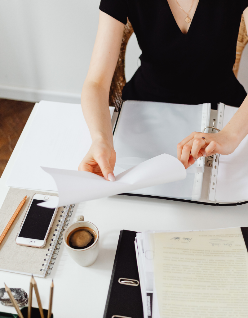 Personne classant des documents administratifs pour déclaration IFU et revenus de capitaux mobiliers