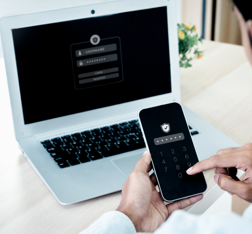 Image d'une personne utilisant la double authentification sur son téléphone mobile, avec un écran de connexion sur un ordinateur portable en arrière-plan.